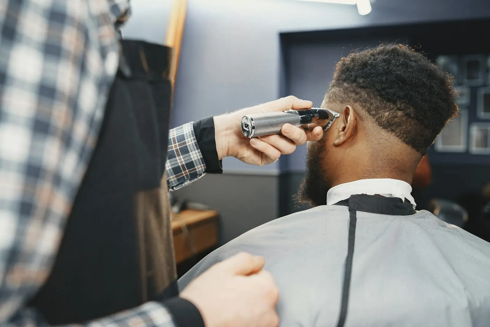 A Locale barber working a clean fade, chair-side